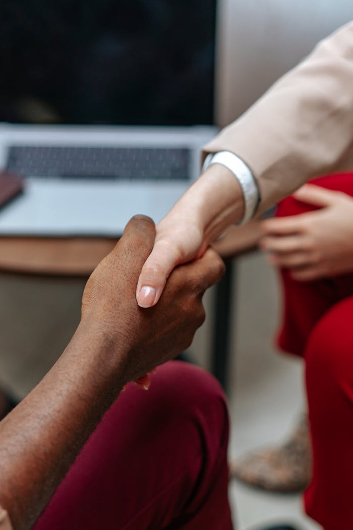 Close-up of a handshake between two diverse professionals in a business environment.